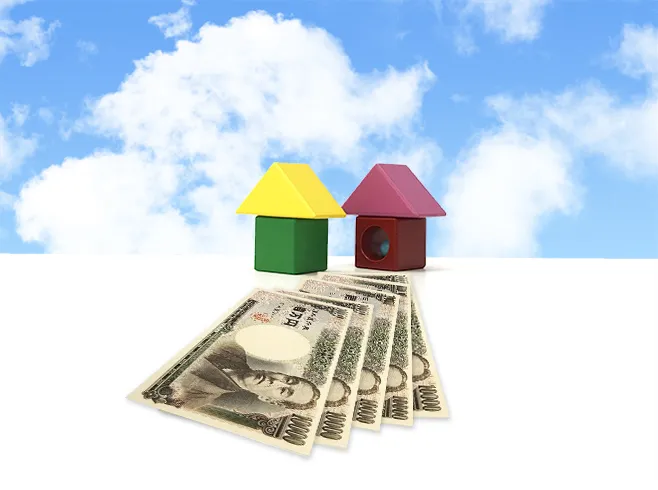 建物模型の前に紙幣が置かれているイメージ画像